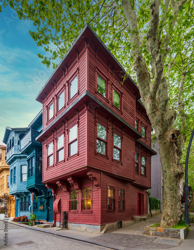 Photography Facade of colorful wooden residential buildings painted in red and blue, with wr