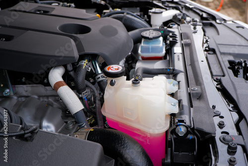 radiator reservoir tank car engine coolant anti-coolant and anti-freeze, pink coolant photo