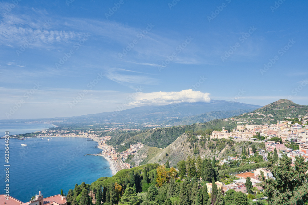 View from Taormina on Giardini Naxos Bay, with Etna volcano in the background in Sicily, Italy