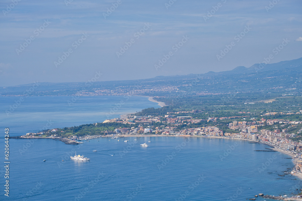 View of the blue sea from Taormina towards the bay in Giardini Naxos, Sicily, Italy