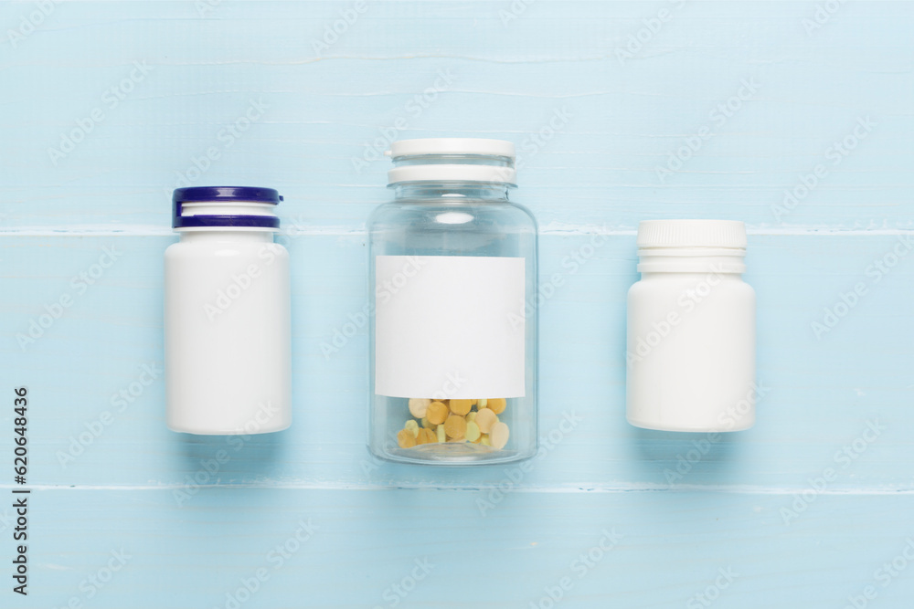 Plastic bottles with vitamins on wooden background, top view Plastic bottles with vitamins on wooden background, top view