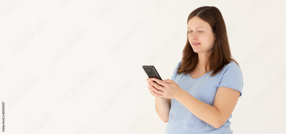 Portrait of a smiling cute pregnant woman using mobile phone isolated on a white background Portrait of a smiling cute pregnant woman using mobile phone isolated on a white background