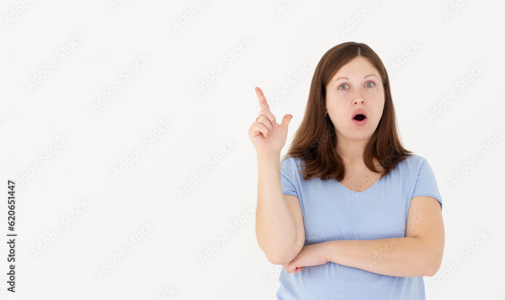 Close-up portrait of charming young pregnant woman in blue t-shirt pointing with finger, looking at camera, isolated on white background Close-up portrait of charming young pregnant woman in blue t-shirt pointing with finger, looking at camera, isolated on white background