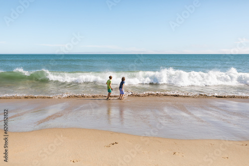 Kids running by the seashore photo