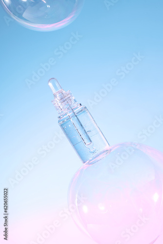 Realistic gel bottle over bubbles on light blue background.
