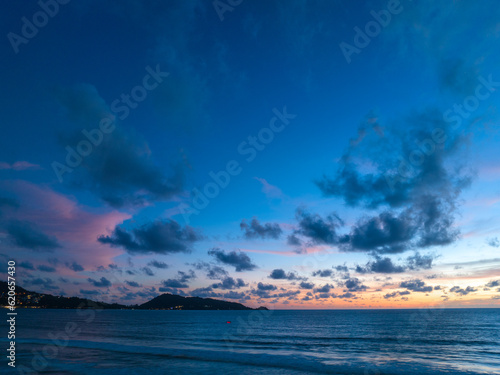 Drones take pictures of the beautiful sky by the beach in stunning sunset..colorful sky in sunset above Patong city at twilight. .Scene of romantic sky sunset background.