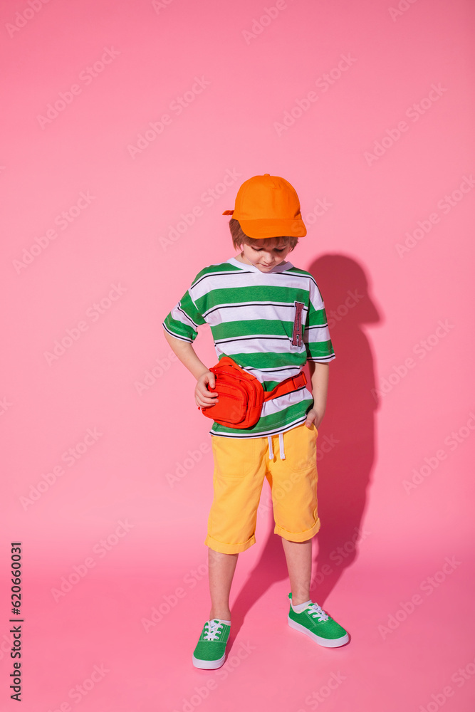 Stylish kid posing on bright pink background Stylish kid posing on bright pink background