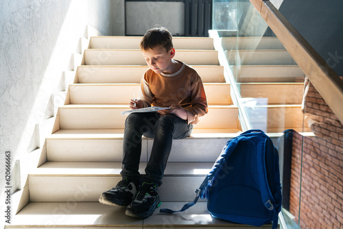 little student sitting on the stairs photo