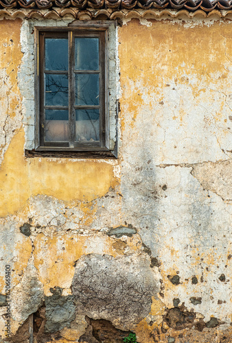 Colorful, old distressed window and painted wall