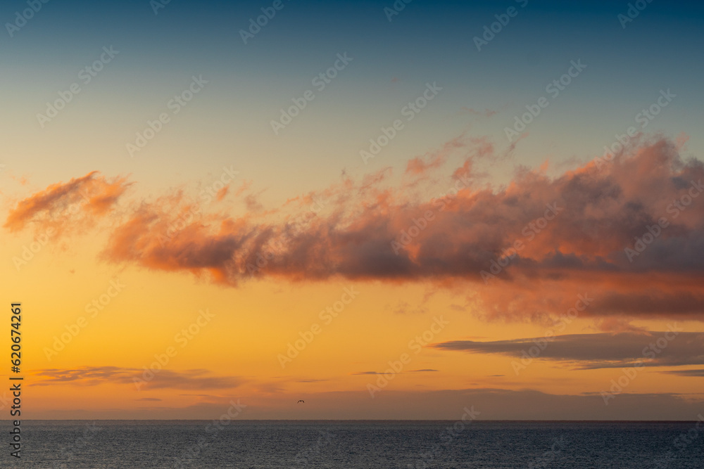 Pink and orange clouds above the Mediterranean Sea at the sunset. Perfect time for meditation concept.