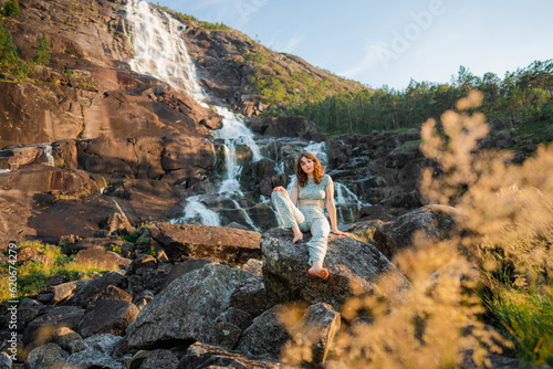 Woman near waterfall in mountains  photo