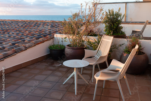 Hotel terrace on the Mediterranean seashore at sunrise or the residential building balcony with the sea view. Patio design concept.