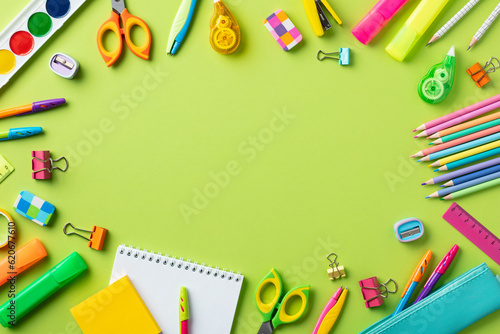 Back to school concept. Flat lay composition with school supplies on green background.