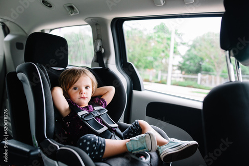 Toddler girl relaxes in her carseat