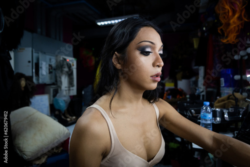 A Thai transgender performance aritst finishes her makeup photo