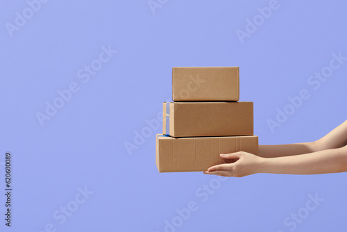 hands holding boxes stacked on color isolated background photo