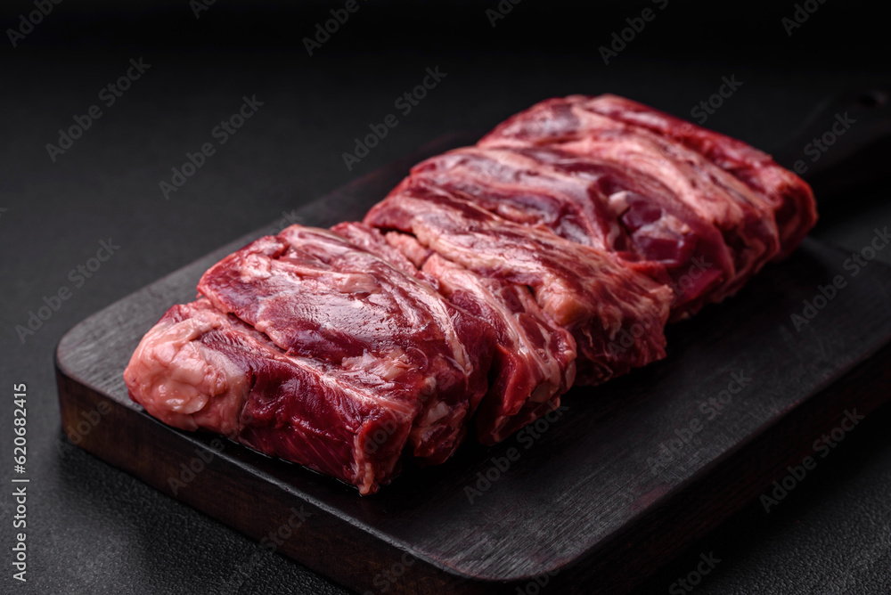 Fresh raw beef ribs with salt, spices and herbs