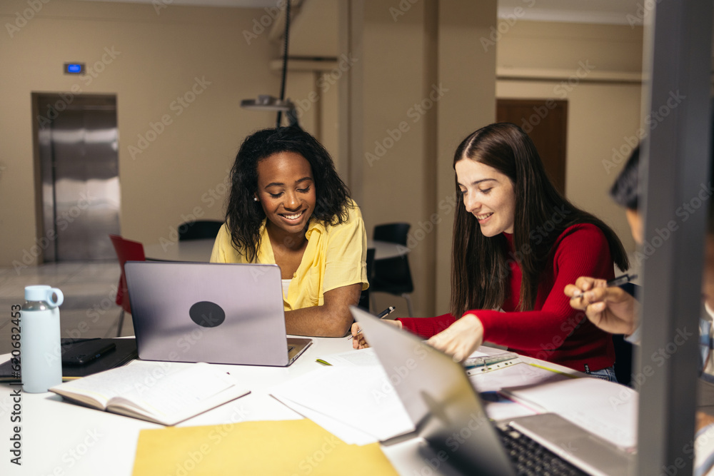 Students doing work and studying with laptops and notes in the college Students doing work and studying with laptops and notes in the college