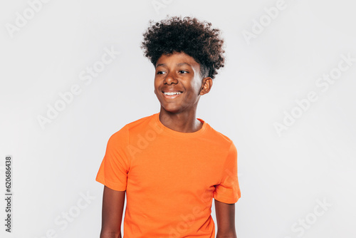 Cheerful black kid in orange t-shirt photo