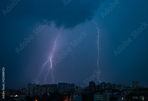 Lightning strike over dark blue sky in night city Kiev, Ukraine
