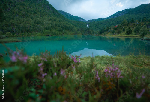 Pristine turquoise lake in Norway surrounded by mountains  photo