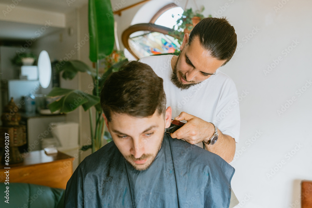 Barber focused in a haircut Barber focused in a haircut