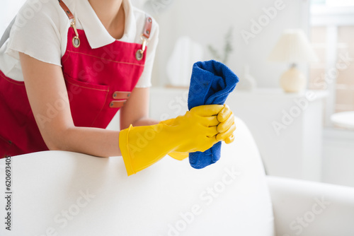 Asian female housewife cleaning the house.