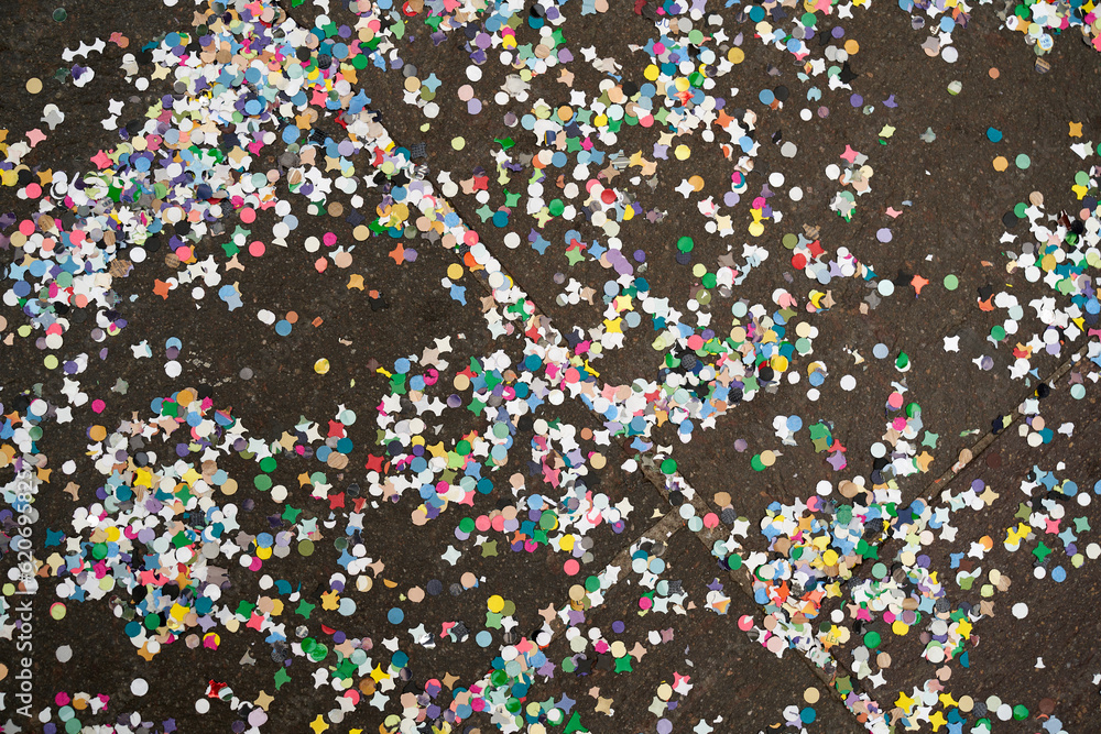 Many multi colored confetti on floor after party.