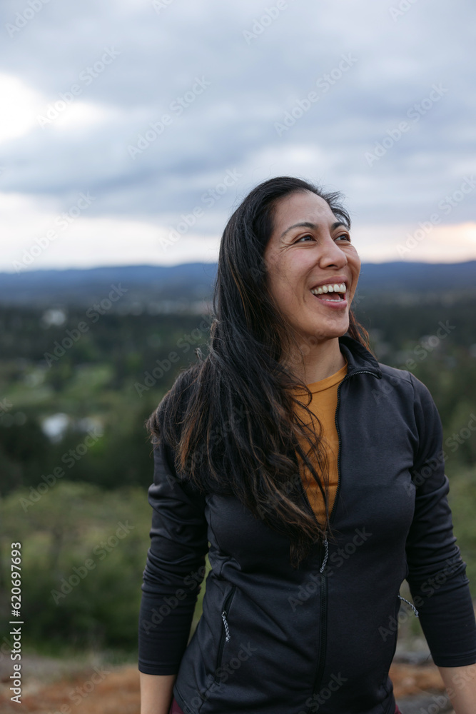 Happy laughing woman outdoors on top of mountain. Happy laughing woman outdoors on top of mountain.