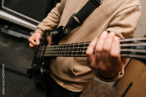 Unrecognizable musician playing bass guitar