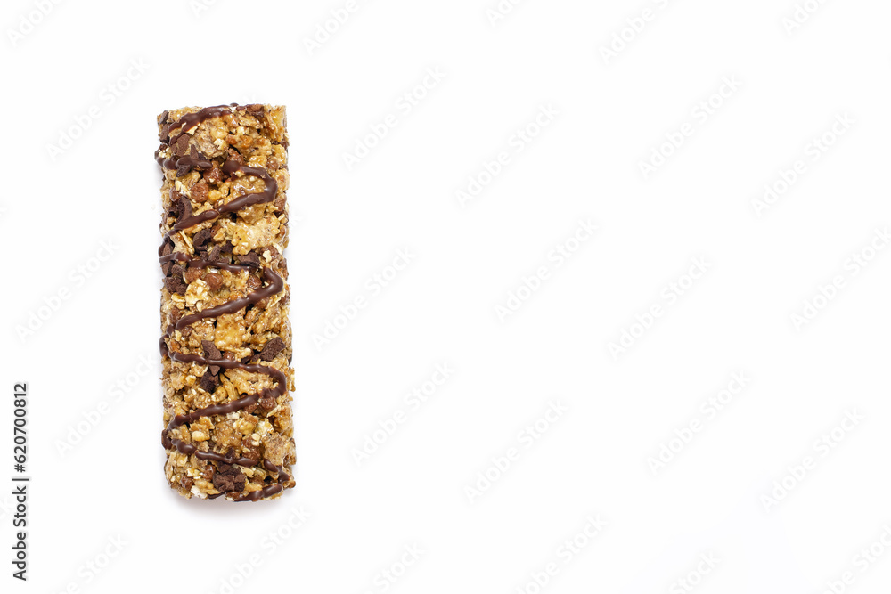 Muesli bar on a white isolated background. Whole grain energy bar with chocolate. Healthy food in the form of a sweet healthy bar. Healthy quick snack. Free space for text Muesli bar on a white isolated background. Whole grain energy bar with chocolate. Healthy food in the form of a sweet healthy bar. Healthy quick snack. Free space for text