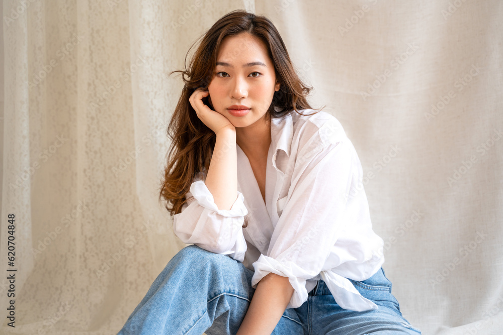 Asian woman posing on fabric backdrop. Asian woman posing on fabric backdrop.