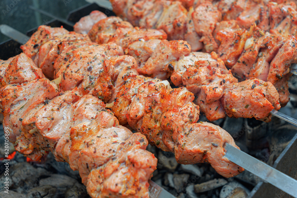 Pork skewers, roasted on skewers on the grill. Shashlik meat shish kebab on the grill. traditional outdoor barbecue picnic.