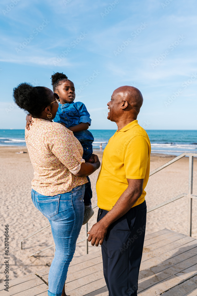 Happy family with daughter on beach near sea Happy family with daughter on beach near sea