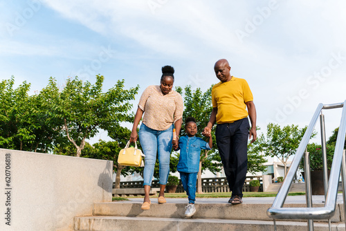 Black family walking in green park photo