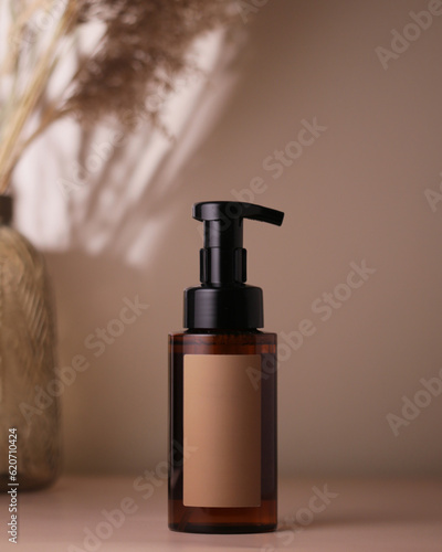brown bottle with cosmetic product photo