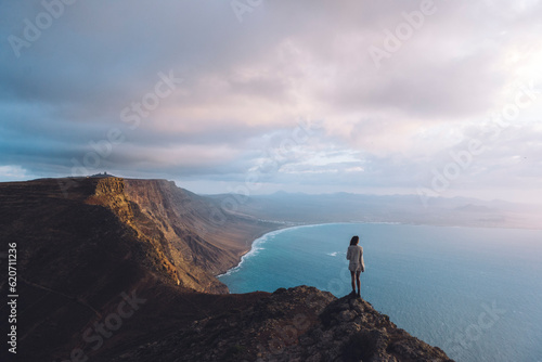 girl in viewpoint in front of the ocean photo