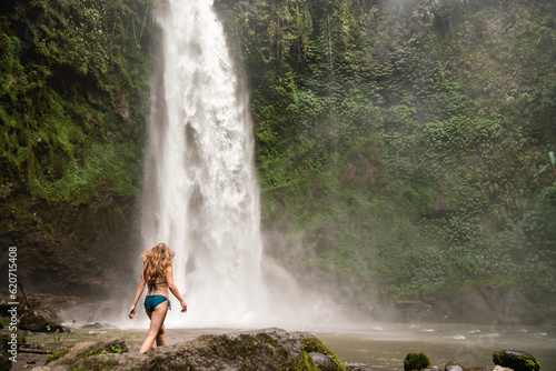 Woman In Swimwear Walking At Waterfall In Bali photo