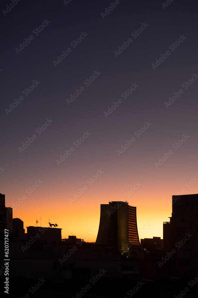 Sunrise during a summer day in Brazil with bright horizon and building Sunrise during a summer day in Brazil with bright horizon and building