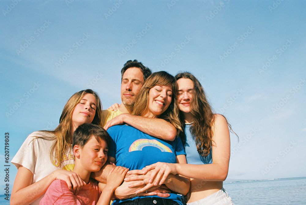 family portrait on beach and ocean in maui family portrait on beach and ocean in maui