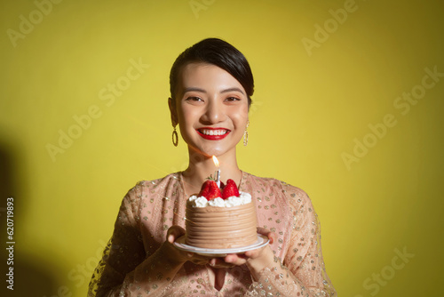 Image of beautiful asian woman over yellow photo