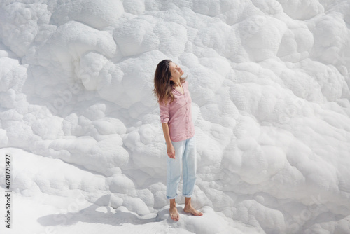 Young pretty woman having fun in snow-white limestone terrain photo