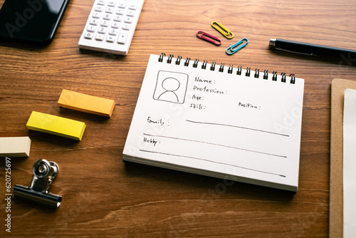 A notebook with a diagram of the persona is on the desk.