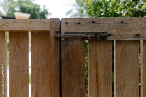 A wooden gate with a lock