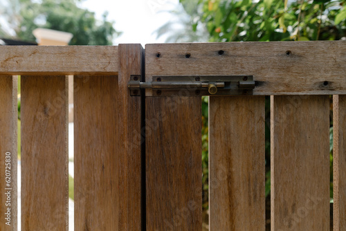 A wooden gate with a lock photo