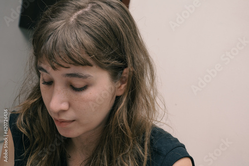 Portrait of a young blonde woman looking down