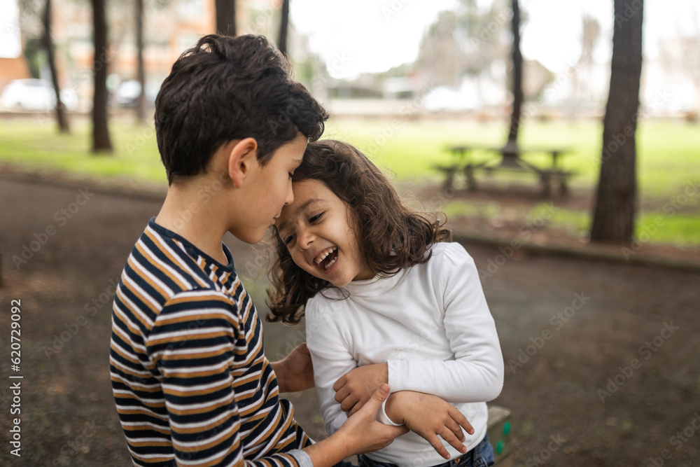 children playing happily outdoors in nature children playing happily outdoors in nature