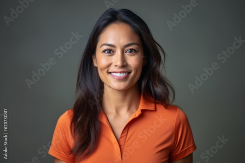 Lifestyle portrait photography of a pleased woman in her 30s wearing a sporty polo shirt against a minimalist or empty room background