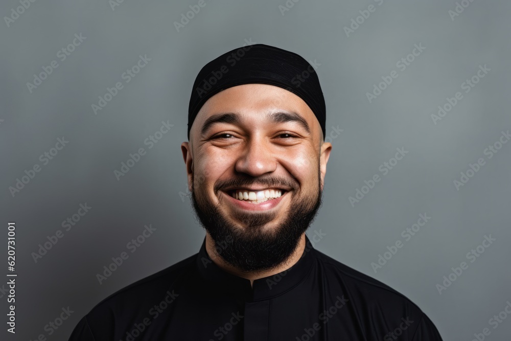 Portrait of a smiling asian muslim man on grey background Portrait of a smiling asian muslim man on grey background