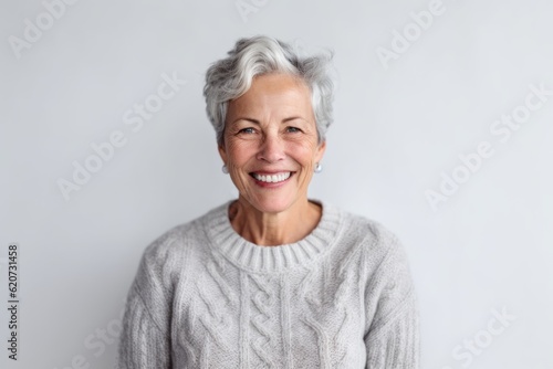 Portrait of smiling senior woman looking at camera. Senior woman with grey hair.